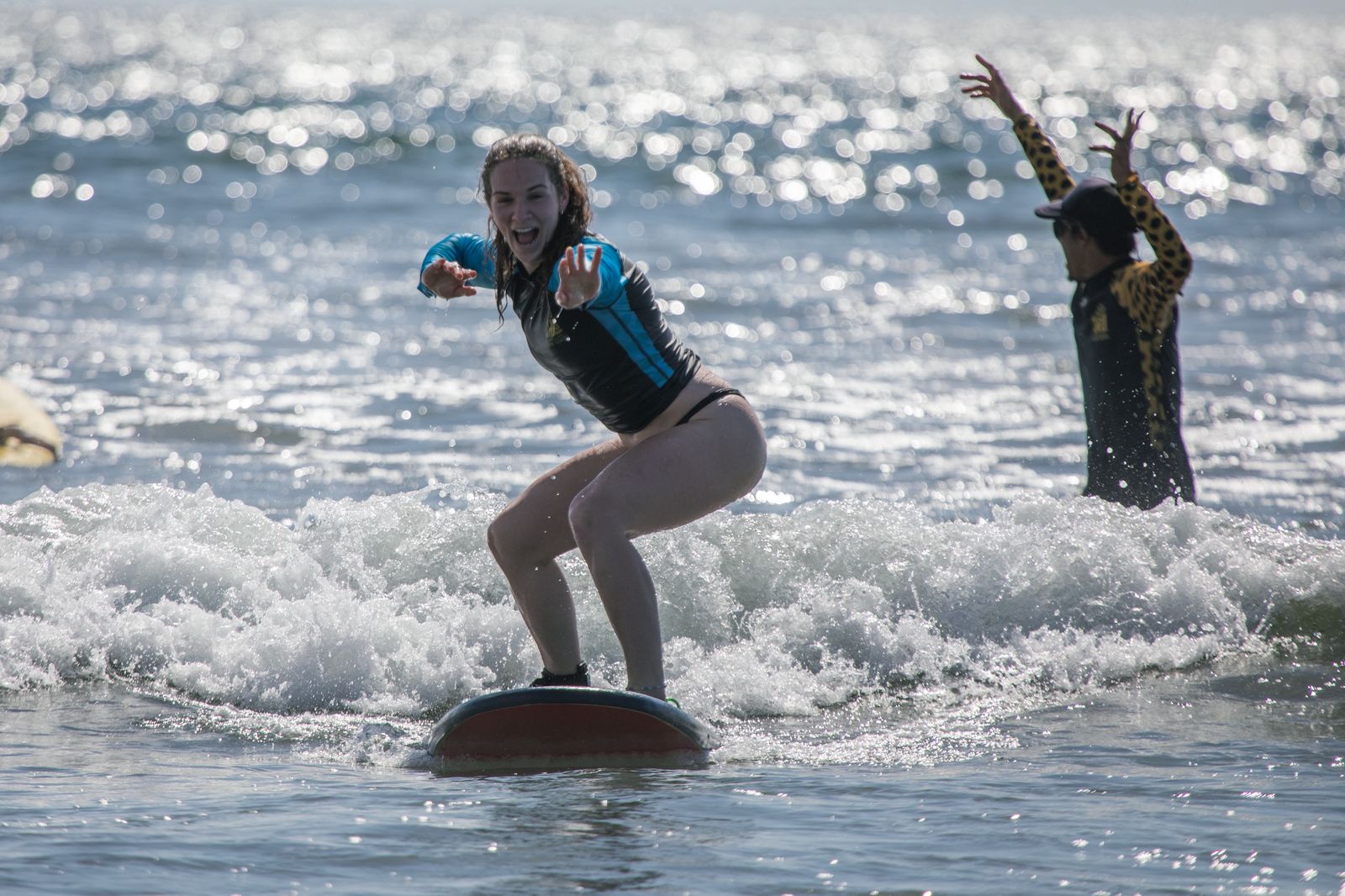 Student celebrating her first wave with Chelo coach cheering
